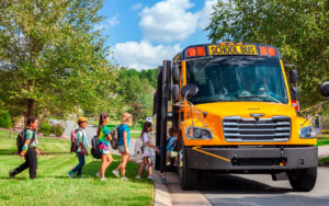 Young children entering school Thomas Built C2 bus.